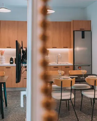 a kitchen and dining room with tables and chairs at Elegant Intimate Studio in Piraeus near Pasalimani in Piraeus