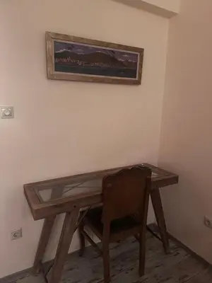 a wooden desk with a chair and a picture on the wall at Athens centre brand new apartment in Athens