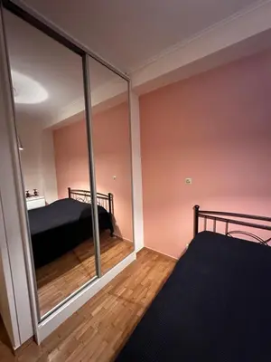 a bedroom with a bed and a large glass window at Athens centre brand new apartment in Athens