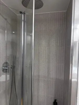 a shower in a bathroom with a glass door at Athens centre brand new apartment in Athens