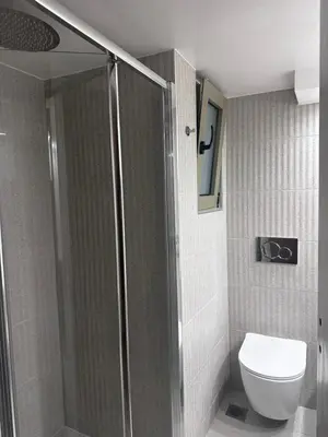 a bathroom with a shower and a toilet at Athens centre brand new apartment in Athens