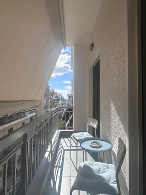 a balcony with a table and chairs on a balcony at Athens centre brand new apartment in Athens