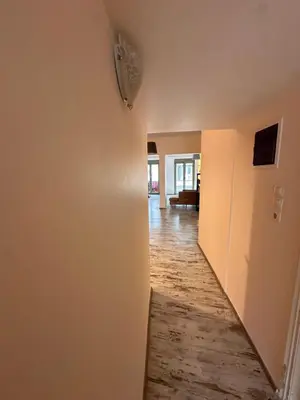 a hallway of a home with a room with white walls at Athens centre brand new apartment in Athens