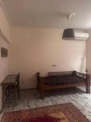 a bedroom with a bed and a table in a room at Athens centre brand new apartment in Athens