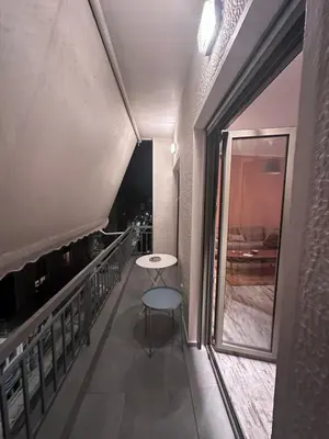 a small table on the balcony of a building at Athens centre brand new apartment in Athens