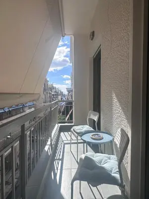 a balcony with two chairs and a table on a balcony at Athens centre brand new apartment in Athens