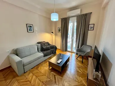 a living room with a couch and a table at Cozy apartment in Athens in Athens