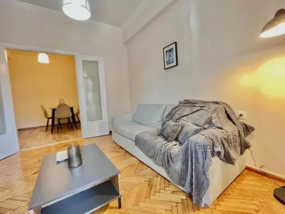 a living room with a couch and a table at Cozy apartment in Athens in Athens