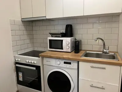 a kitchen with a microwave and a sink at Cozy apartment in Athens in Athens