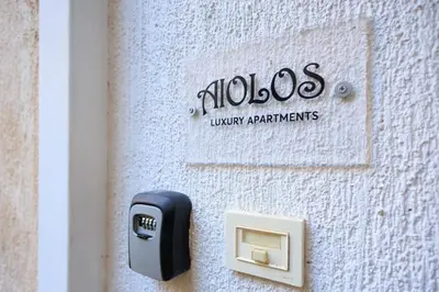 a phone on the side of a building at Aiolos Lux and Easy suite near the sea alimos in Athens