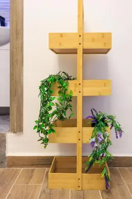 a wooden shelf with plants on a wall at Aiolos Lux and Easy suite near the sea alimos in Athens