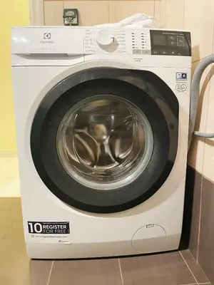 a white washing machine sitting in a kitchen at Bluebay comfort apartment Paleo Faliro in Athens