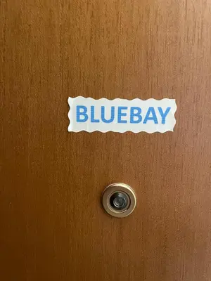 a sign on a wooden door with blueberry on it at Bluebay comfort apartment Paleo Faliro in Athens