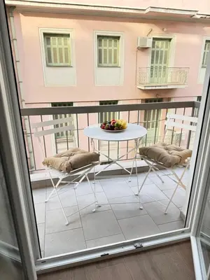 a balcony with a table and chairs on a balcony at Athens Pulse in Athens