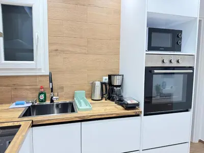 a kitchen with a sink and a microwave at Athens Pulse in Athens
