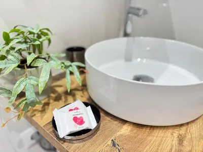 a bathroom with a sink and a table with a plant at Athens Pulse in Athens