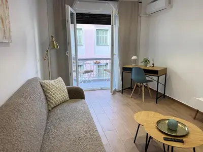 a living room with a couch and a table at Athens Pulse in Athens