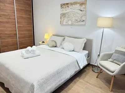 a bedroom with a white bed and a chair at Athens Pulse in Athens
