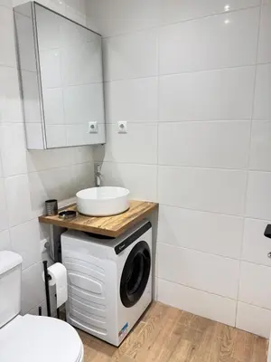 a bathroom with a washing machine and a sink at Athens Pulse in Athens