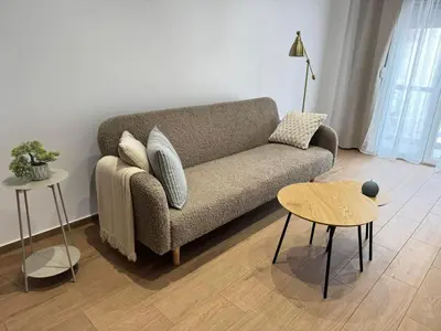 a living room with a couch and two tables at Athens Pulse in Athens