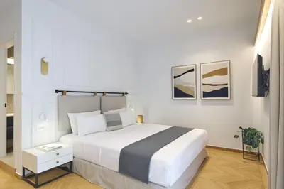a white bedroom with a large white bed in it at The Athenian Chic Elegant Apartments in Kolonaki in Athens