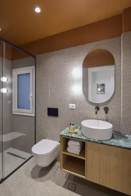 a bathroom with a sink and a toilet and a mirror at The Athenian Chic Elegant Apartments in Kolonaki in Athens