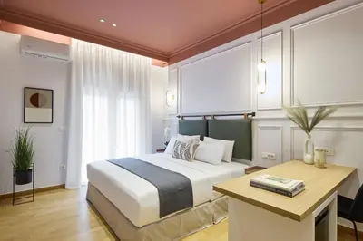 a bedroom with a bed and a desk in it at The Athenian Chic Elegant Apartments in Kolonaki in Athens