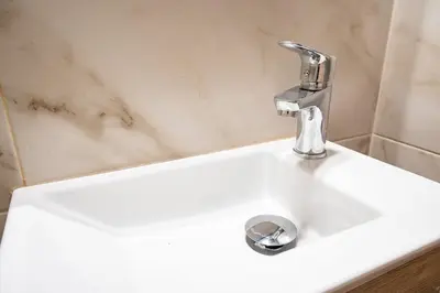 a white sink with a faucet in a bathroom at Gyzi Center Studio by MPS in Athens