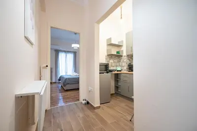 a room with a kitchen and a living room at Gyzi Center Studio by MPS in Athens