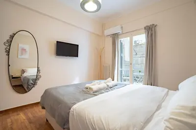 a bedroom with a large bed and a mirror at Gyzi Center Studio by MPS in Athens