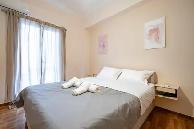 a bedroom with a bed with a stuffed animal on it at Gyzi Center Studio by MPS in Athens