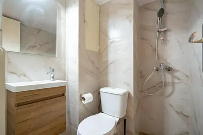 a bathroom with a shower and a toilet and a sink at Gyzi Center Studio by MPS in Athens