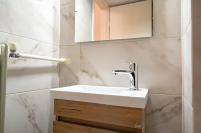 a bathroom with a white sink and a mirror at Gyzi Center Studio by MPS in Athens