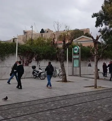 a group of people walking on a sidewalk at Super Central-Acropolis Museum- Metro , 75 m2 in Athens