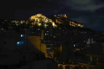 a mountain at night with lights on it at Penthouse! Best views Lycabetous & Parthenon ! EXARCHEIA in Athens