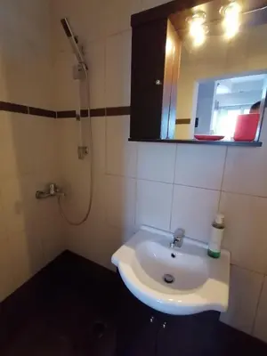 a bathroom with a sink and a mirror and a shower at Penthouse! Best views Lycabetous & Parthenon ! EXARCHEIA in Athens