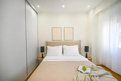 a bedroom with a bed with a book on it at LIV - Marvelous Apartment Near Acropolis in Athens