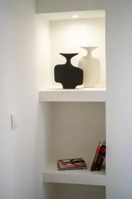 two vases sitting on shelves in a room at LIV - Marvelous Apartment Near Acropolis in Athens