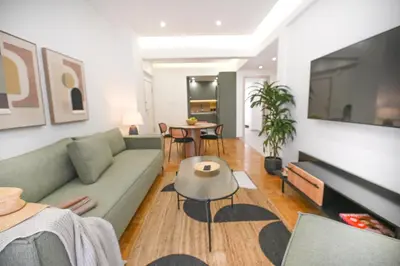 a living room with a couch and a table at LIV - Marvelous Apartment Near Acropolis in Athens