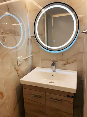 a bathroom with a sink and a mirror at Bluebay Cozy Aparment 8 in Athens