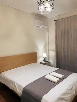 a bedroom with a bed with two towels on it at Bluebay Cozy Aparment 8 in Athens