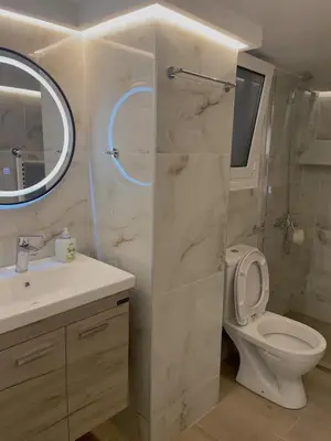 a bathroom with a toilet and a sink and a mirror at Bluebay Cozy Aparment 8 in Athens