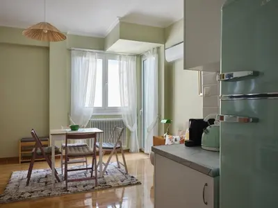 a kitchen with a table and chairs in a room at Stunning-Classical 1bd apartment in Athens