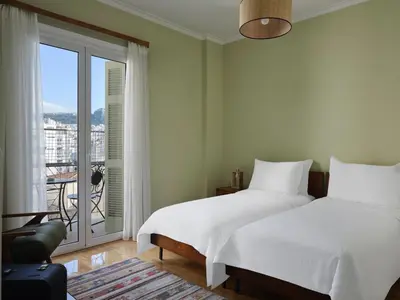a bedroom with two beds and a balcony at Stunning-Classical 1bd apartment in Athens