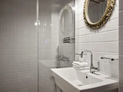 a white bathroom with a sink and a mirror at Stunning-Classical 1bd apartment in Athens