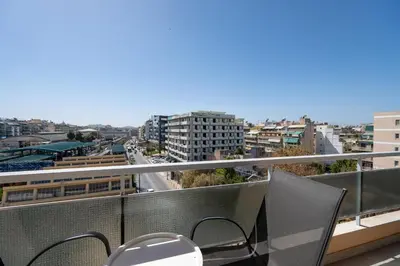 a balcony with chairs and a view of a city at Attiki Square & Metro Modern 2-Bedroom Apt by MPS in Athens