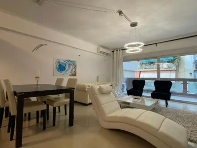 a living room with a table and a dining room at Bluebay comfort apartment 18 in Athens