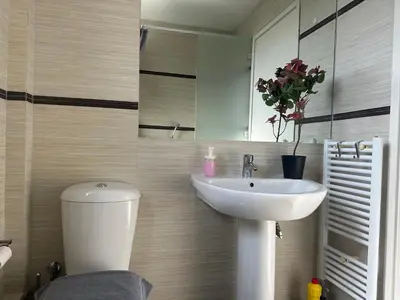 a bathroom with a sink and a toilet and a mirror at Koukaki - Athenian Glow in Athens