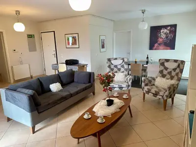 a living room with a couch and a table at Koukaki - Athenian Glow in Athens