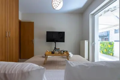 a bedroom with a tv and a table on a bed at Artistic 2bedroom Luxury Hop to Acropolis in Athens